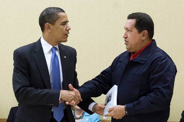 Image: Venezuelan President Hugo Chavez (R) giv